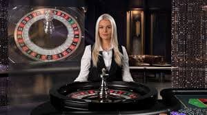 Live dealer casino table with cards and chips on a green felt surface